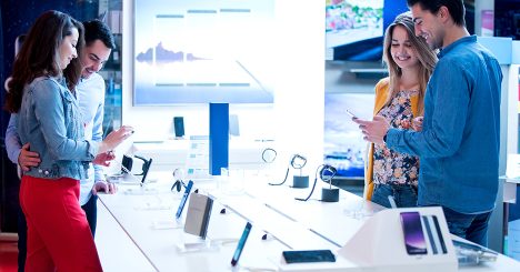 People Looking At Smart Phones At Electronics Store