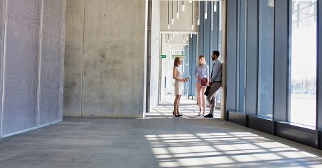 Woman And Two Men In Doorway Of Empty Office Space