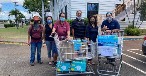 Cades Schutte Volunteers With Shopping Cart Full Of Donations