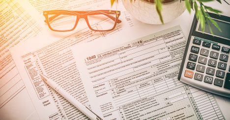 Glasses Pen And Calculator On Tax Forms