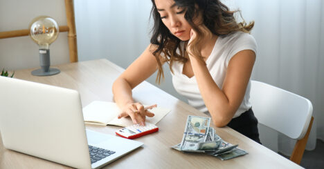 Woman Counting Money At Table