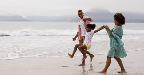 Family Having Fun Together On The Beach